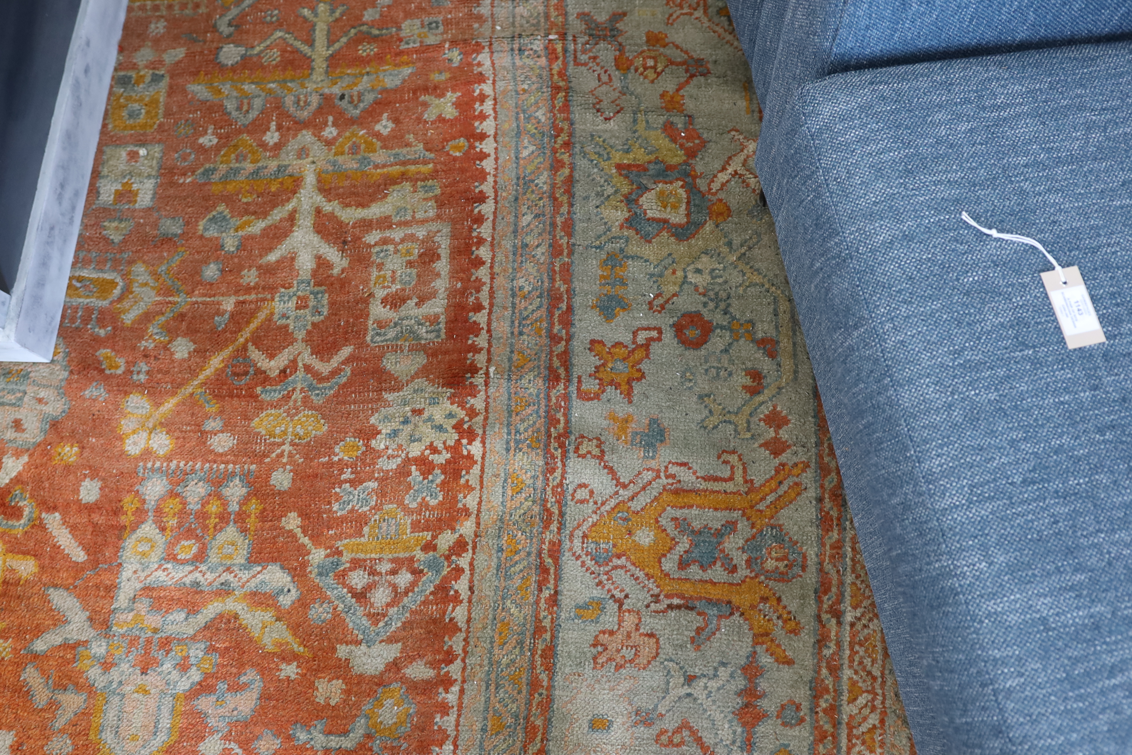 An Afghan red ground carpet, 395 x 310cm
